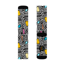 Load image into Gallery viewer, Pair of socks with a colorful abstract pattern on a white background
